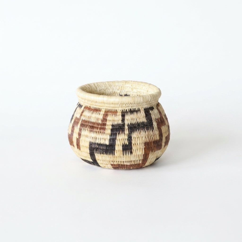 Vintage handwoven Wounaan basket with russet and charcoal stepped geometric pattern on natural tan, Panama