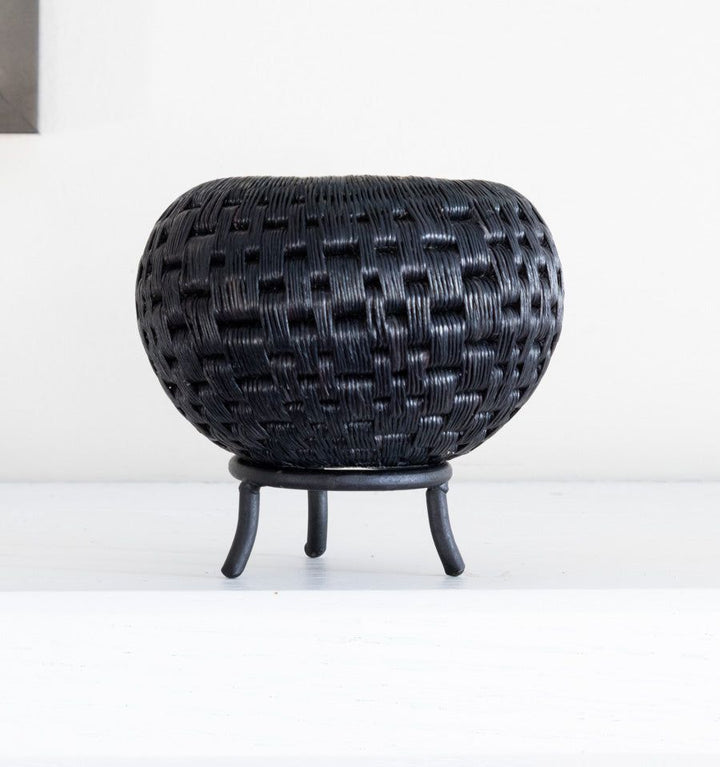 Black metal display stand showcasing mini handwoven decorative basket