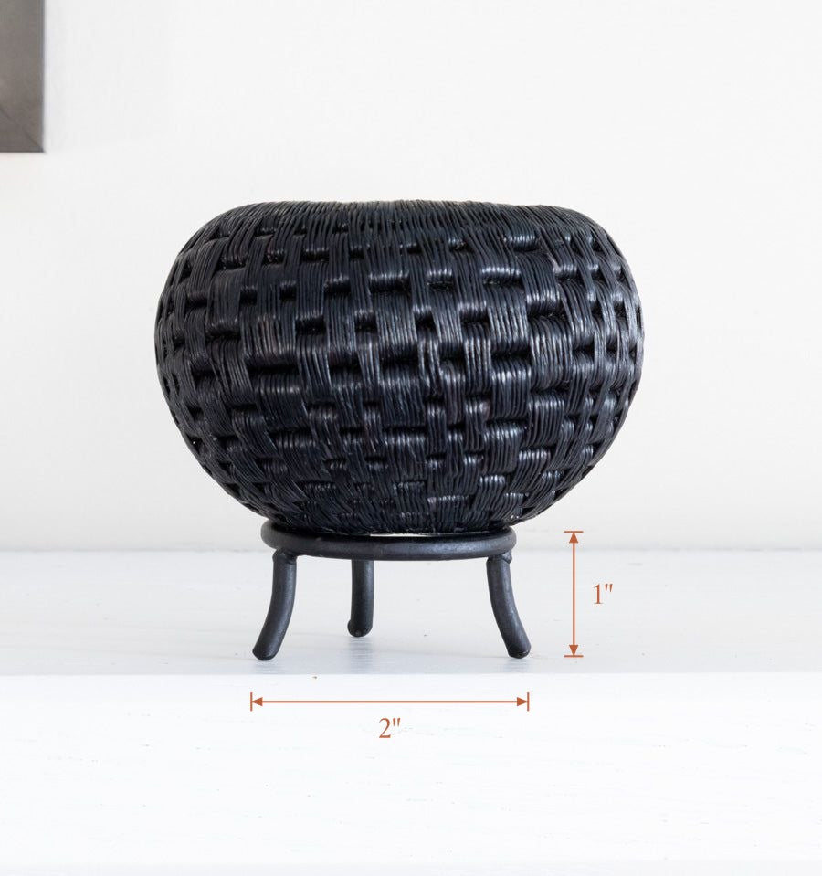 Black metal display stand showcasing mini handwoven decorative basket, stand 2 inches wide by 1 inch tall