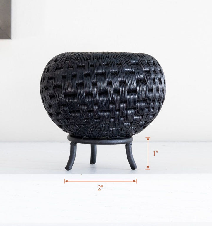 Black metal display stand showcasing mini handwoven decorative basket, stand 2 inches wide by 1 inch tall