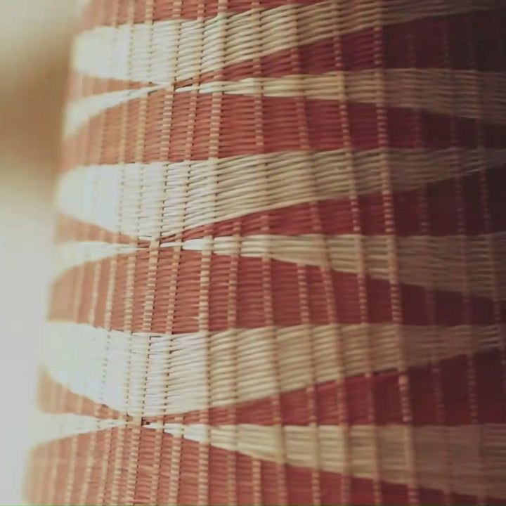 Close-up of tightly coiled golden weave pattern showing traditional Rwandan basketry technique in natural grass fibers