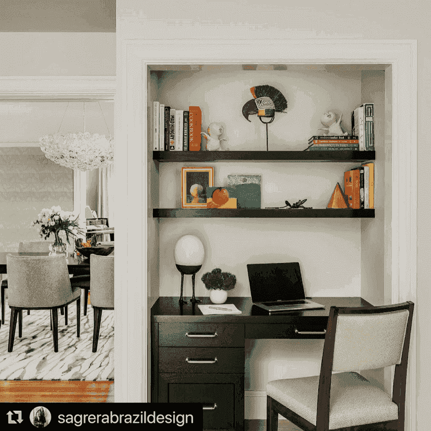 masks displayed on white wall above wooden console in modern bohemian interior