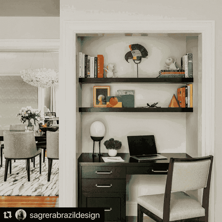 masks displayed on white wall above wooden console in modern bohemian interior