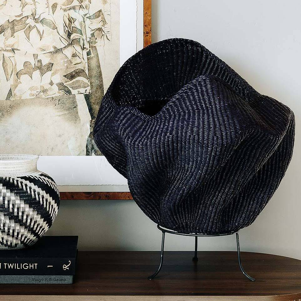Handmade Ghana basket in sculptural wave form with indigo tones woven from elephant grass