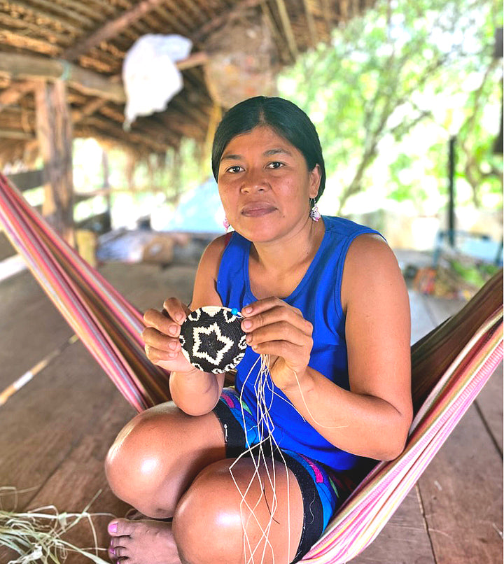 Panama Artisan holding woven basket in progress